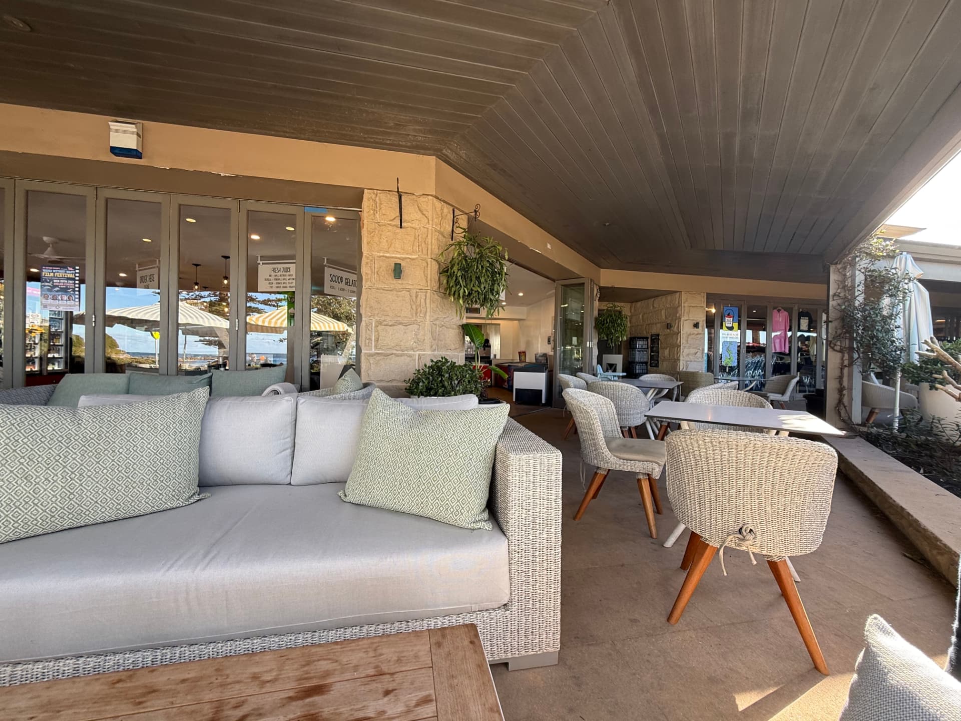 Lounge seating looking through to the beach and the juice and gelato signs
